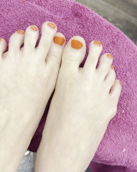 Pumpkin orange gel pedicure done at ES Nail Spa