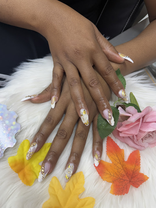 Long white and gold nail tips with raised white flower details